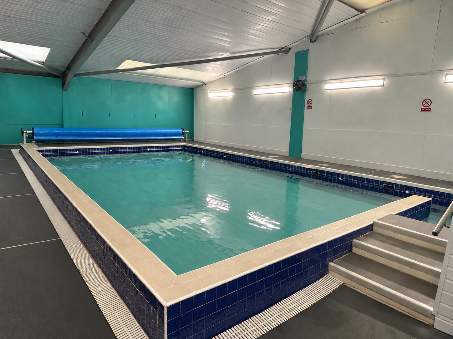 Corner view of the Making Waves Swim teaching pool, showing the pool steps